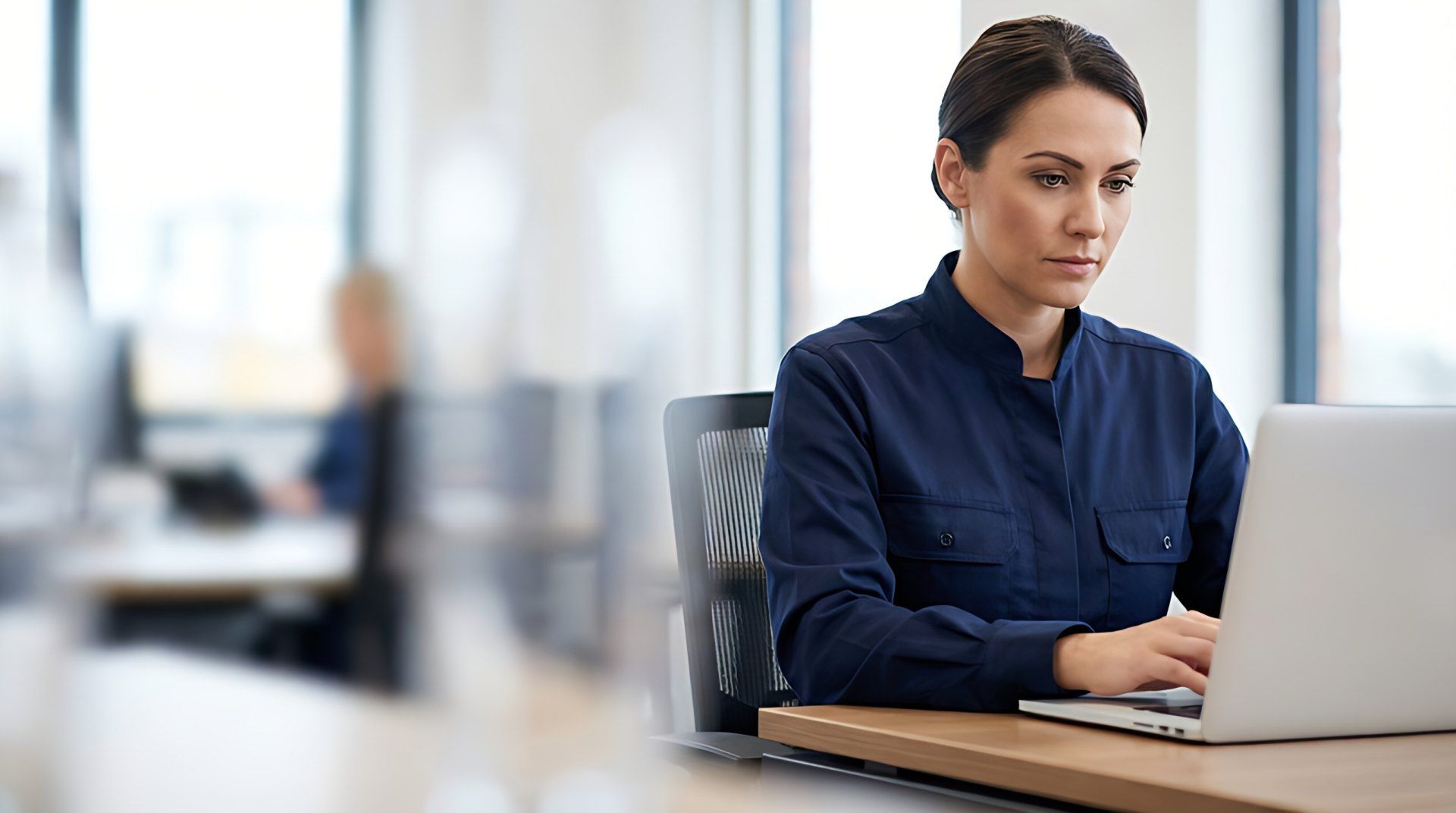 Customs specialist working on a laptop